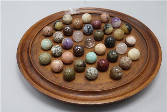 A Victorian solitaire board and marbles